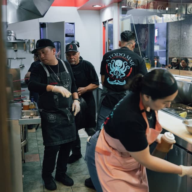 Restaurant team preparing fresh seafood in kitchen